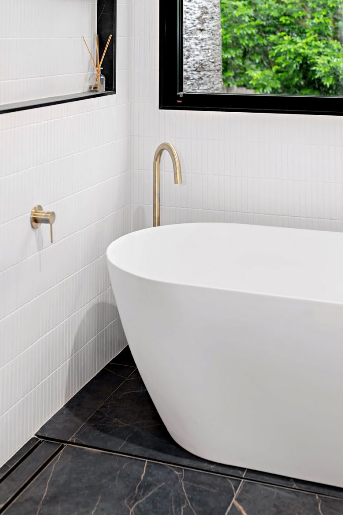 modern tiled bathroom with a freestanding bath rub