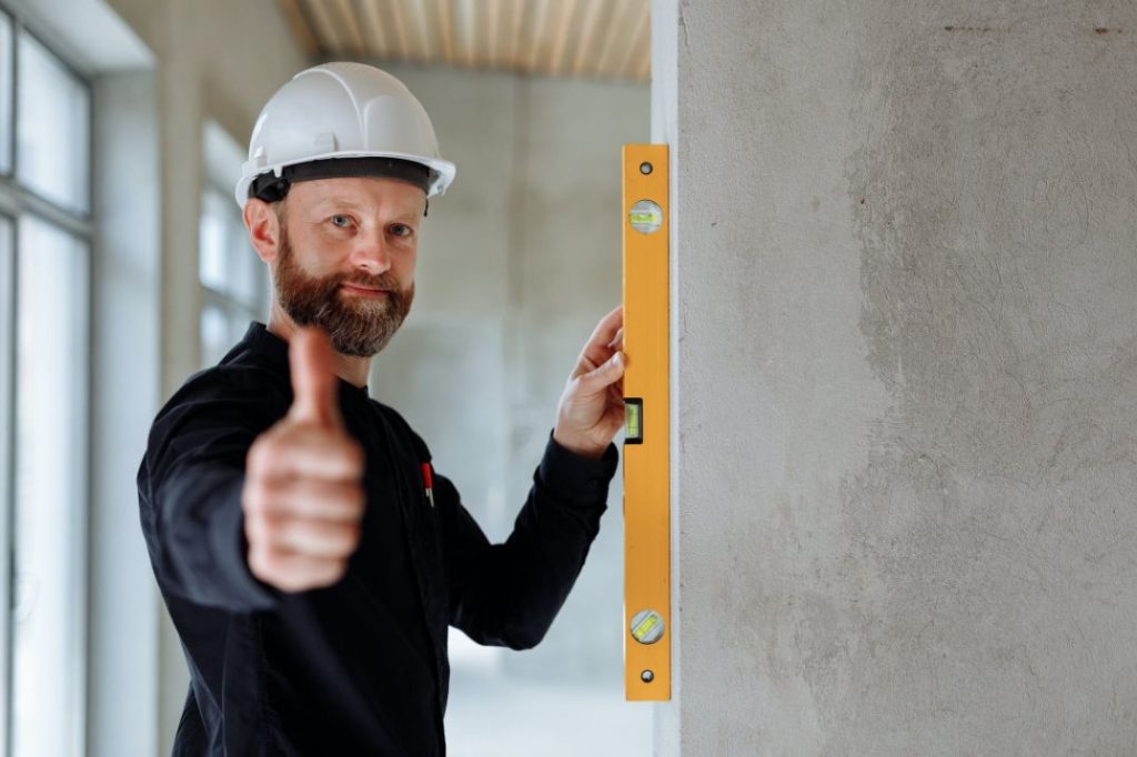 Builder measuring a wall