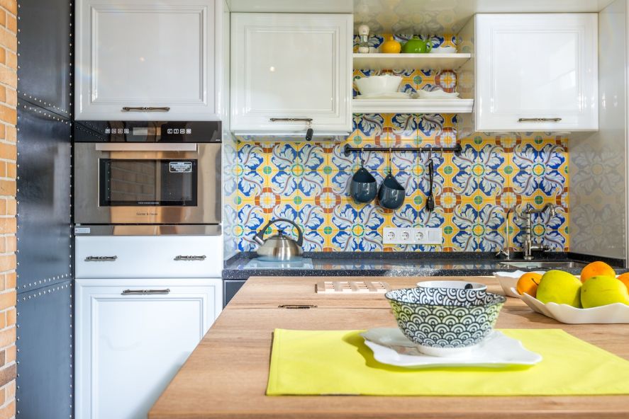 Colourful yellow and blue tiled kitchen