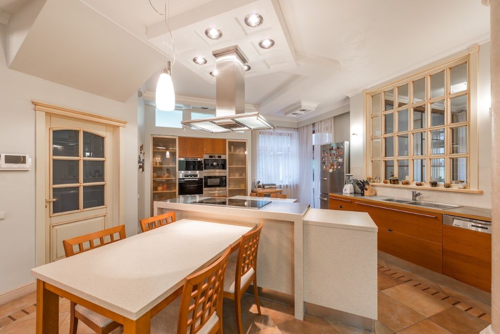 Light grain wooden cabinet kitchen with high ceilings