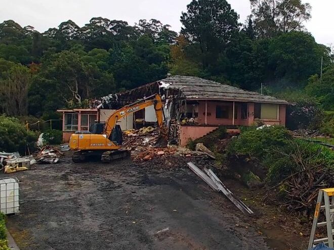 A truck demolishing a home