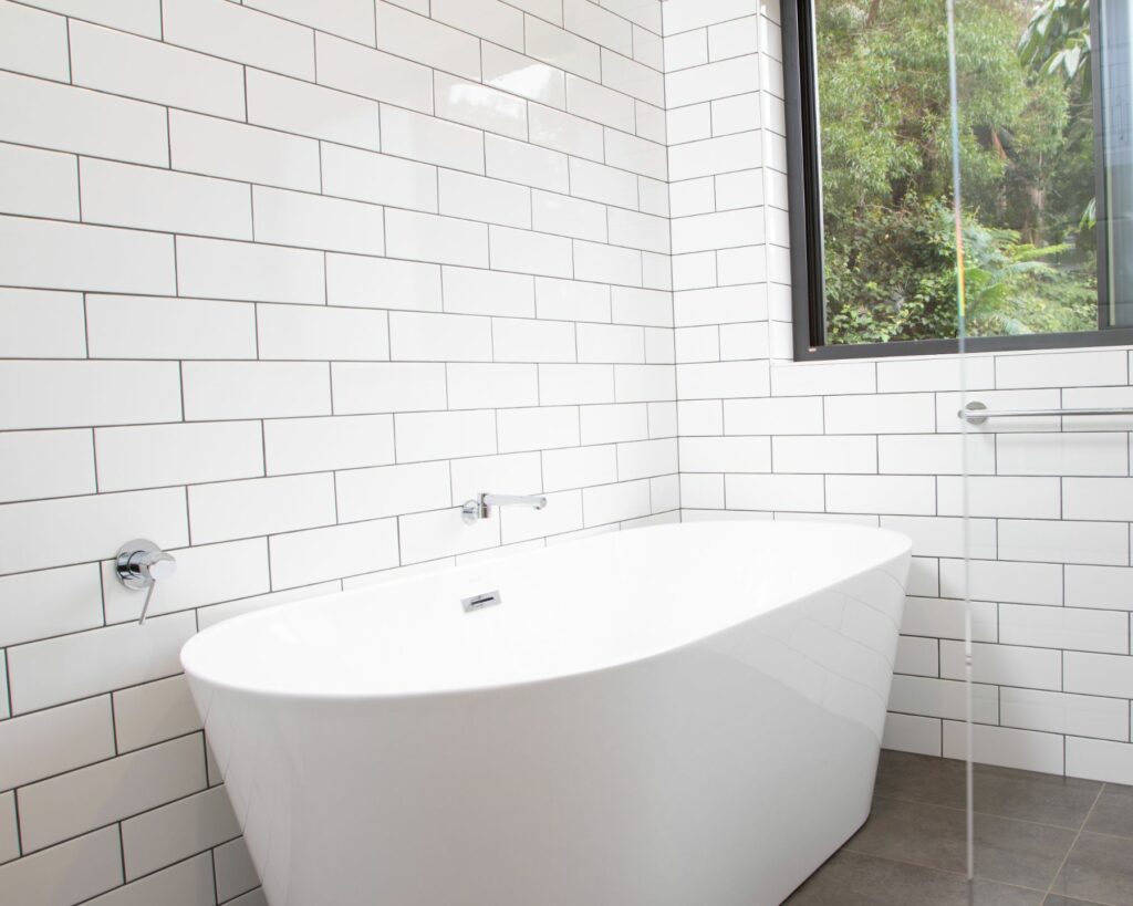 modern bathroom with white tiles and a window