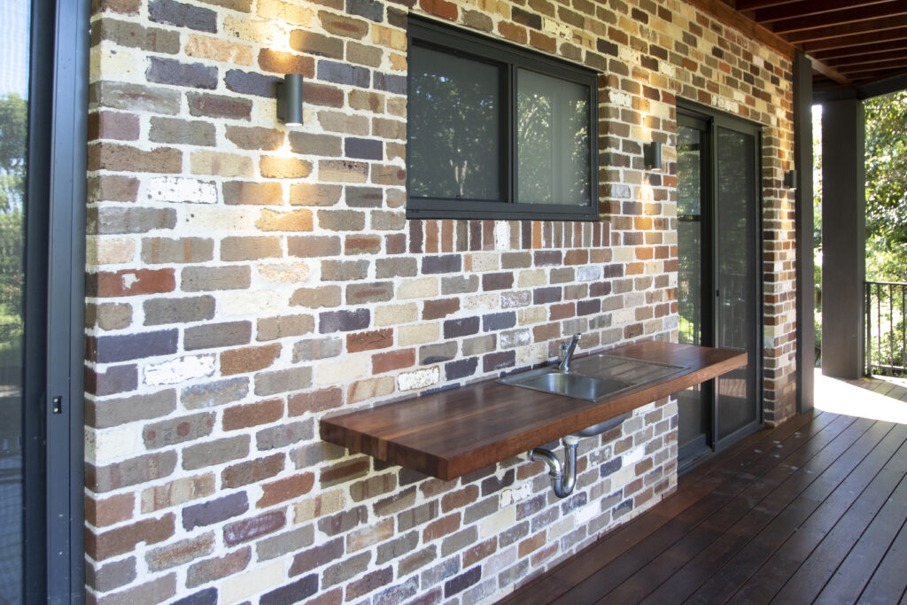brick home with timber details