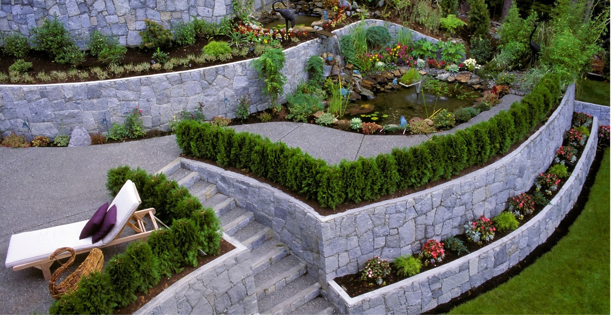 tiered garden with fountain and deck chair