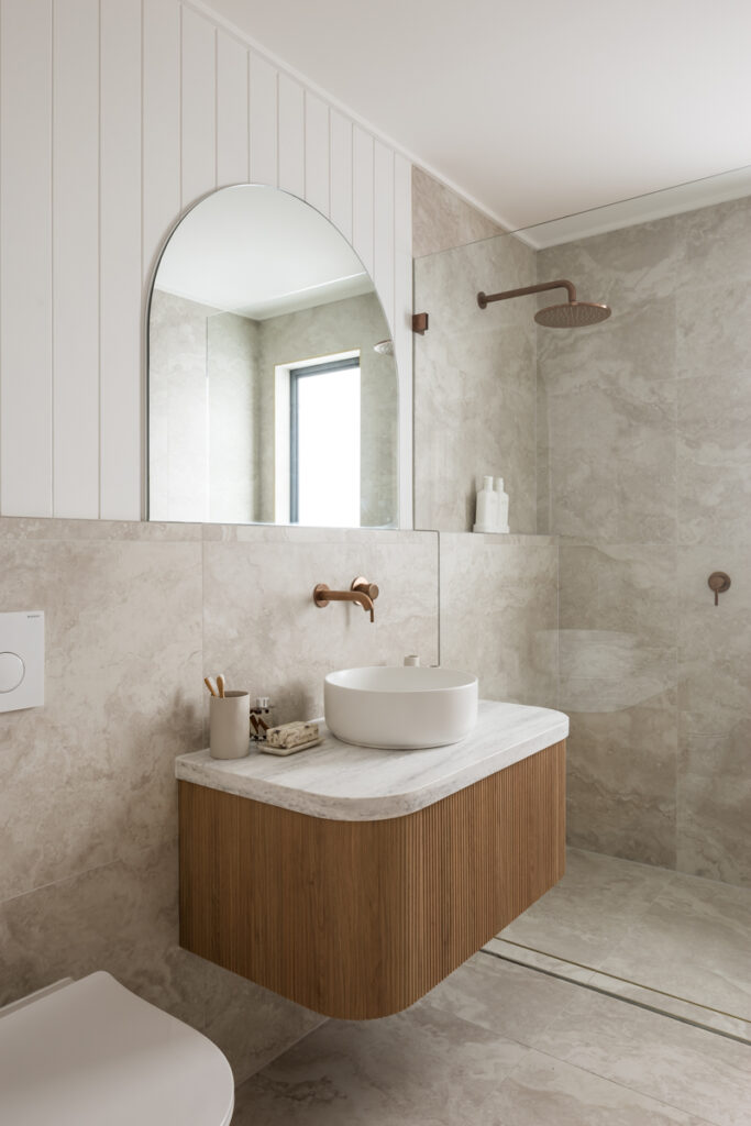 Modern bathroom with black and gold tiles